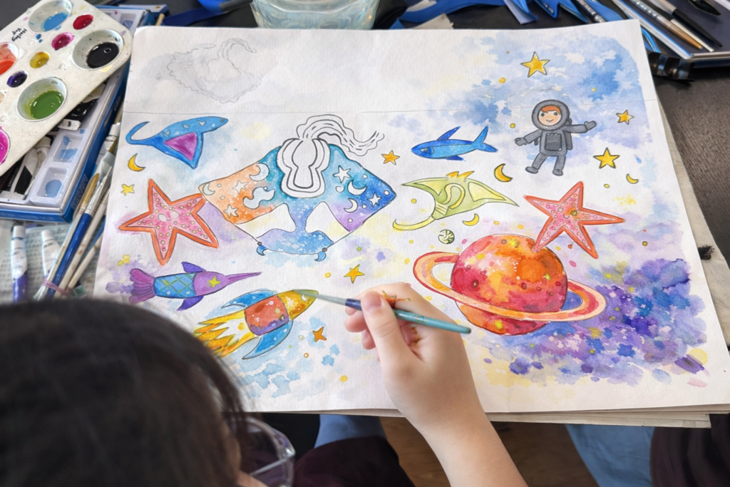 An Artzland teacher guiding a child through comic drawing